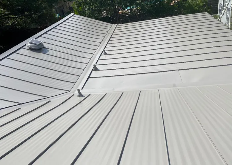 Solar attic fan installed on a metal roof for Roof Ventilation in Parkville